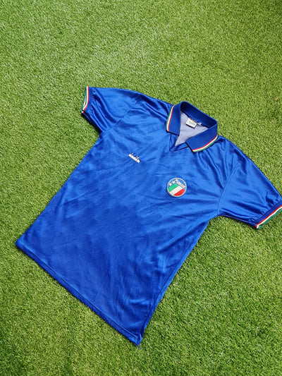 1986-1990 Italy shirt size small made by Diadora on a green background.
